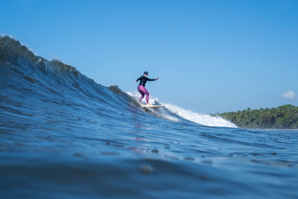 Photo of Stephanie riding a wave