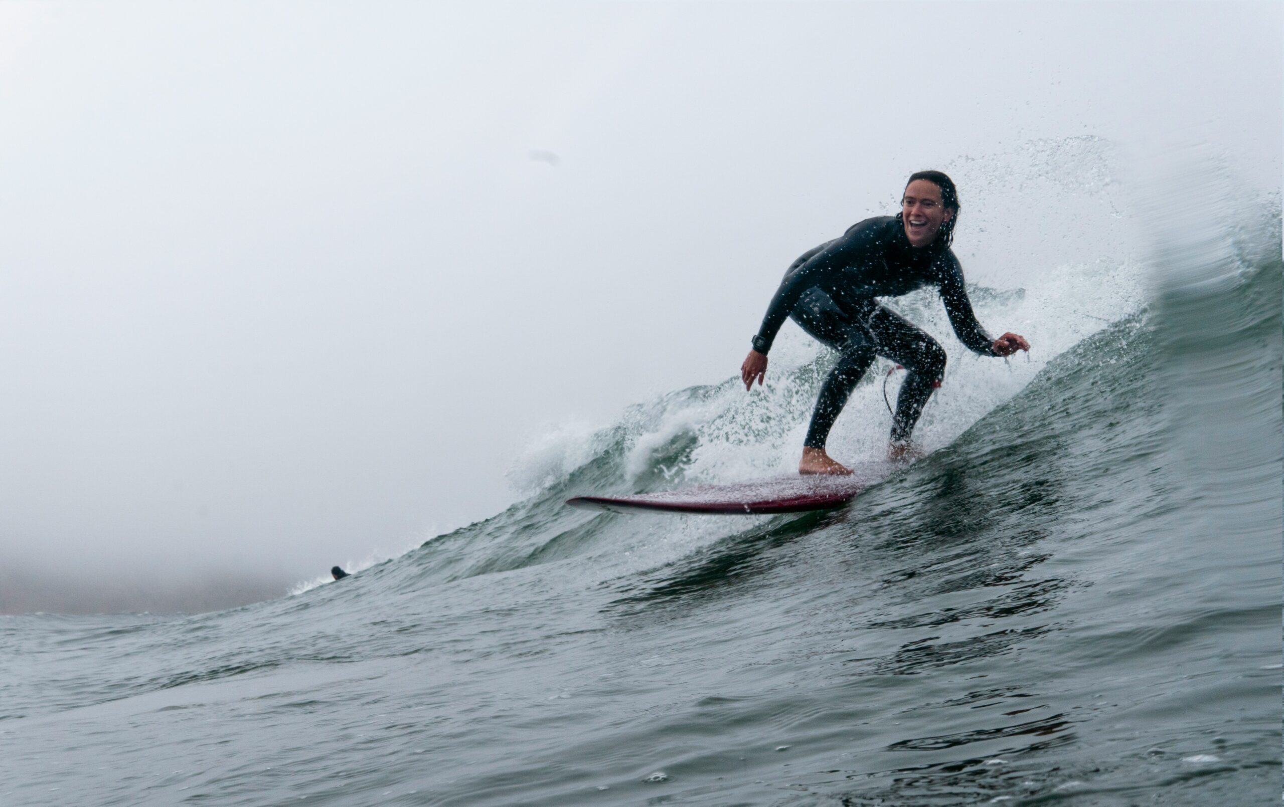 phot of woman surfing on a small wave